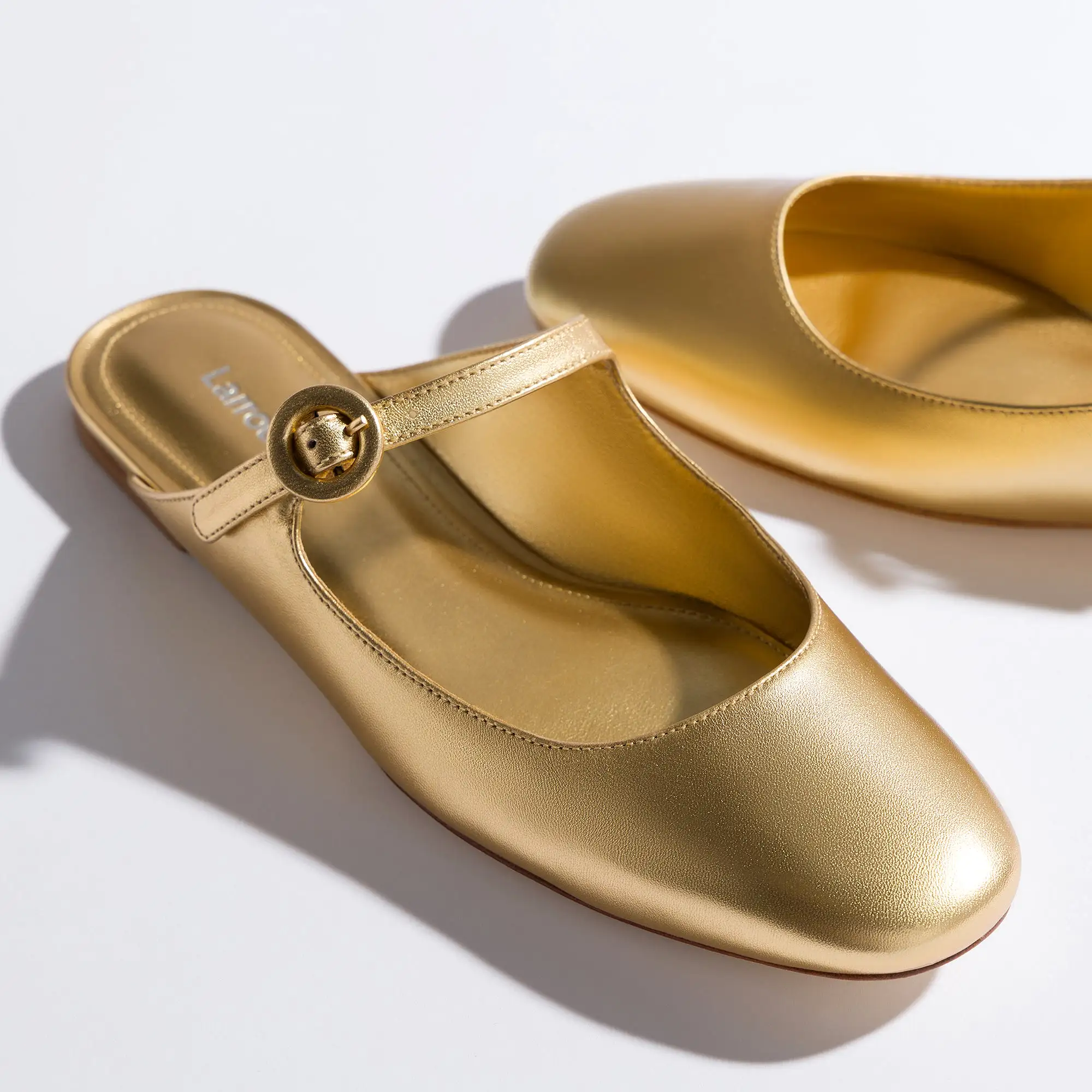 Blair Flat Mule In Gold Metallic Leather